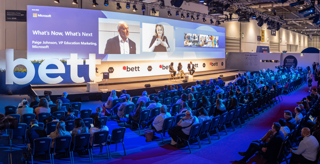 A photo of a large audience at a Bett stage at Bett UK 2022.